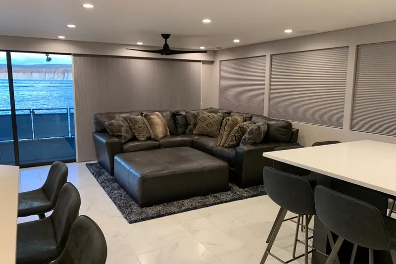 Slide: The Image of Luxurious houseboat interior with leather seating, modern decor, and scenic water view. Adonia Utopia Trip 2019. - 5