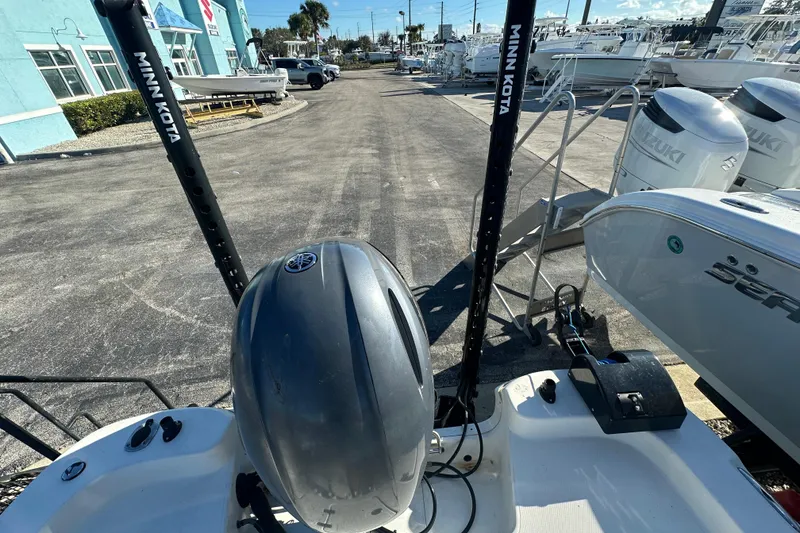 Slide: The Image of 2015 NauticStar 1810 NauticBay boat with Minn Kota accessories in a marina setting. - 14