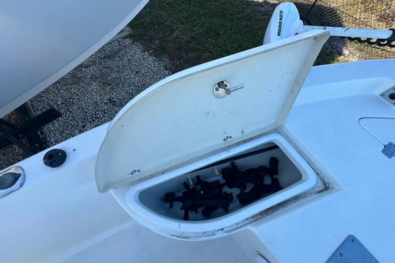 Slide: The Image of 2015 NauticStar 1810 NauticBay boat storage compartment open, showing interior contents. - 7