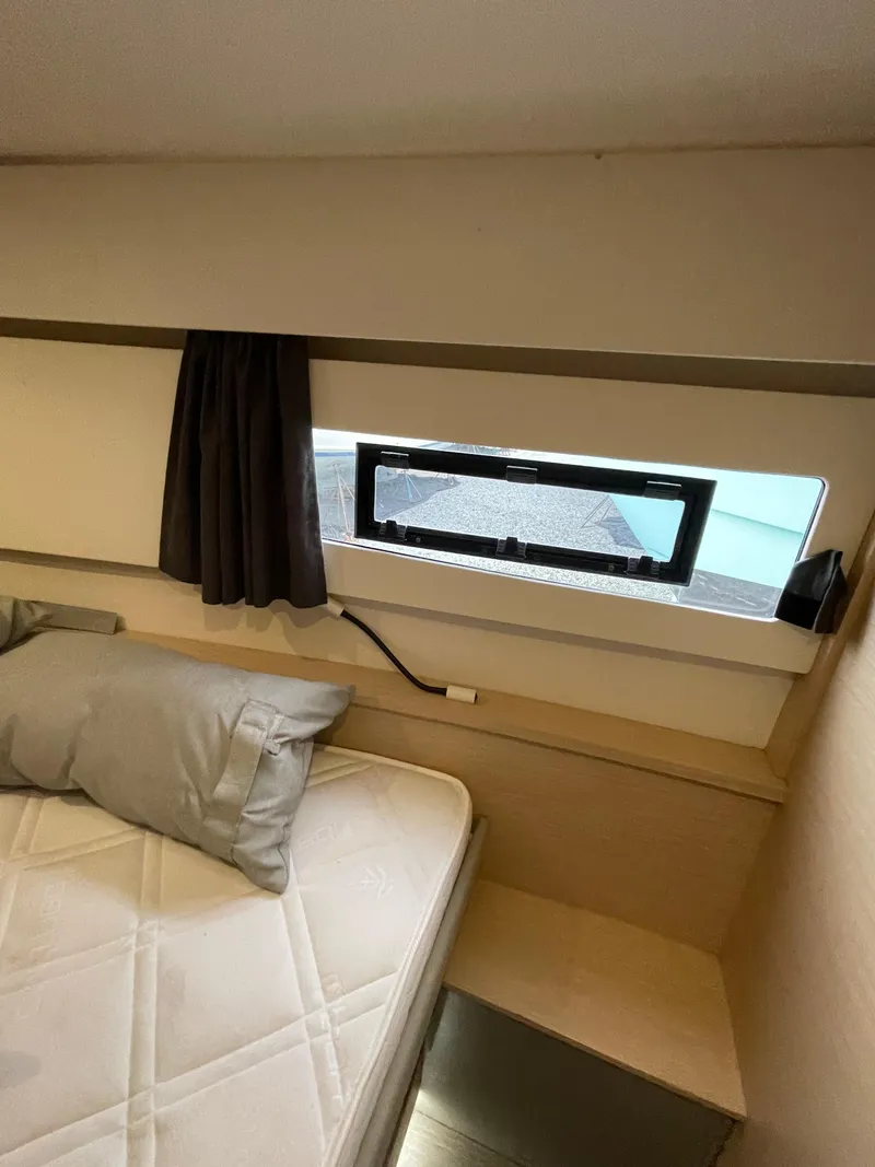 Slide: The Image of 2018 Fountaine Pajot MY 37 cabin interior with bed, window, and curtain. - 10