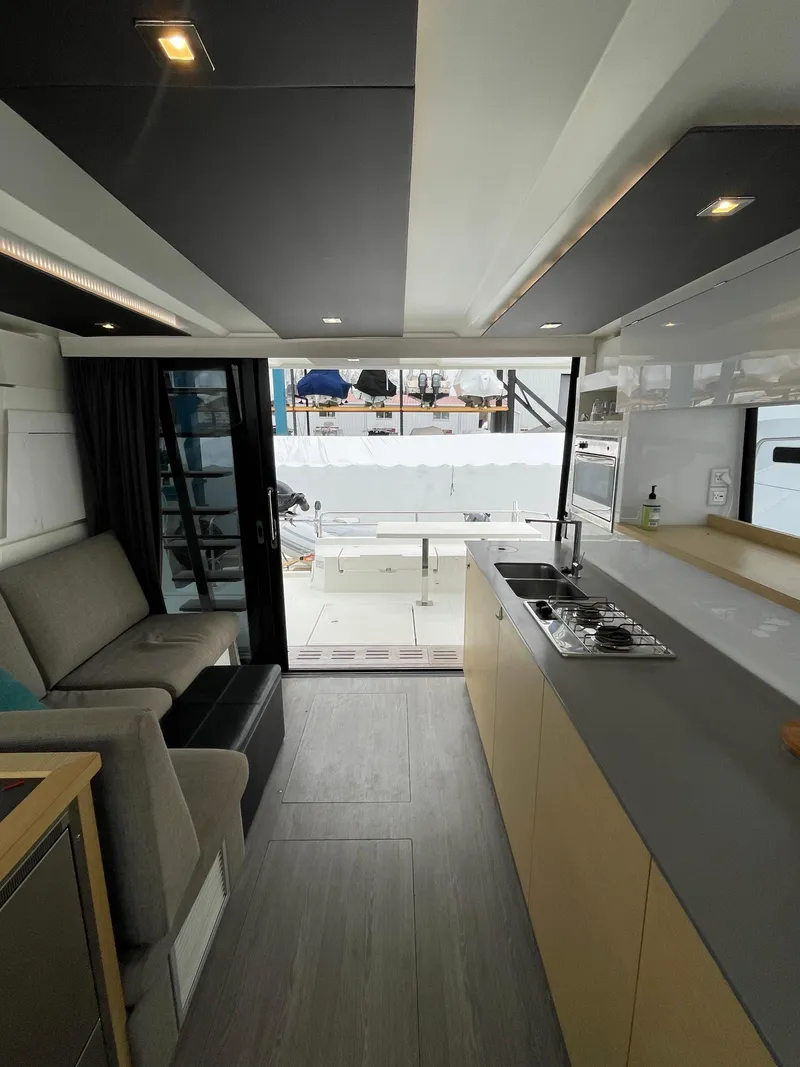 Slide: The Image of Interior of 2018 Fountaine Pajot MY 37 yacht, featuring modern kitchen and seating area. - 16