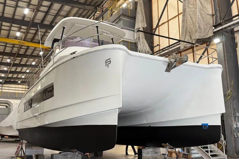 Slide: The Image of 2018 Fountaine Pajot MY 37 yacht in a shipyard, elevated on blocks. - 2