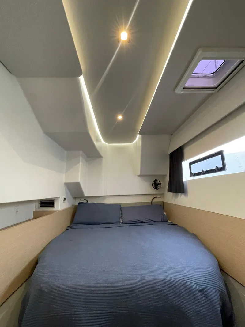 Slide: The Image of 2018 Fountaine Pajot MY 37 cabin interior with modern lighting and cozy bedding. - 18