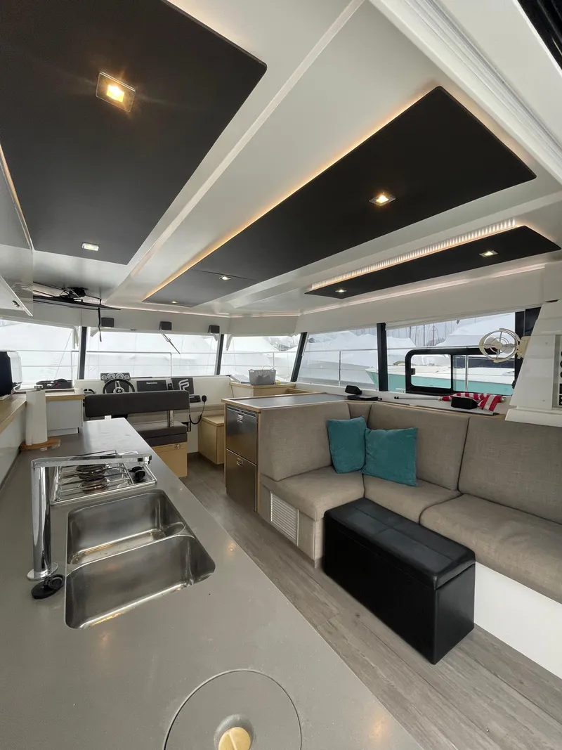 Slide: The Image of Interior of 2018 Fountaine Pajot MY 37 yacht, featuring modern kitchen and seating area. - 22