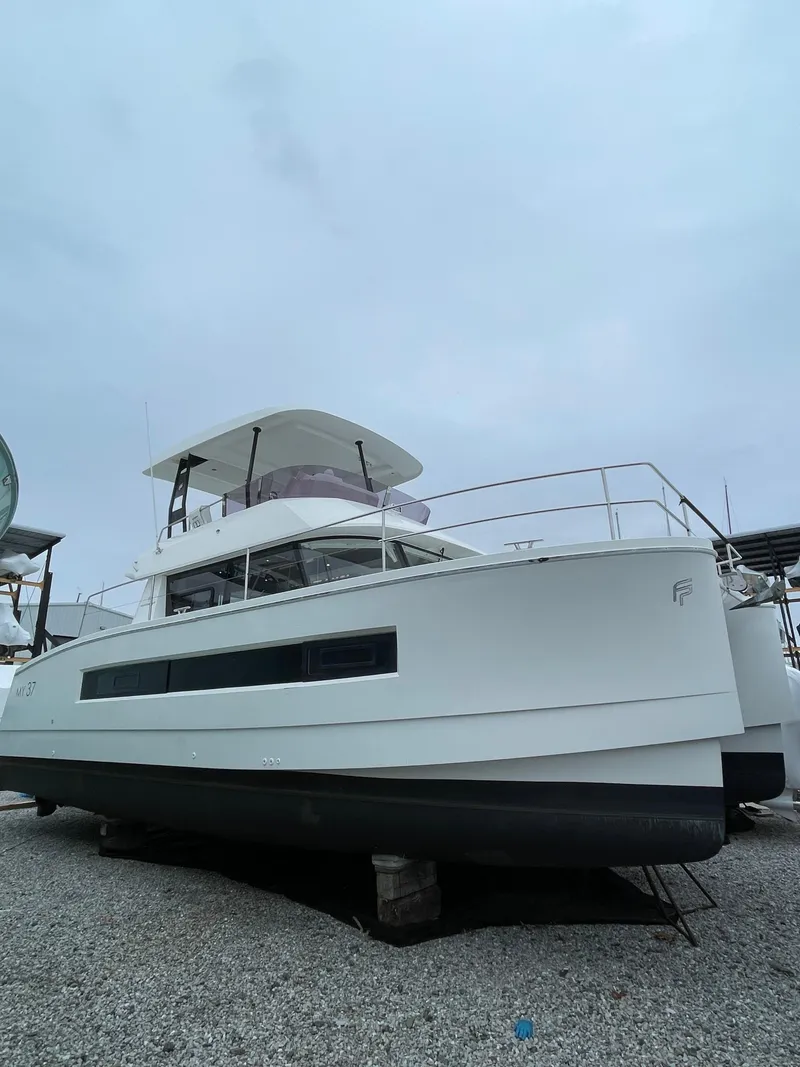 Slide: The Image of 2018 Fountaine Pajot MY 37 catamaran on land, showcasing sleek design and modern features. - 3