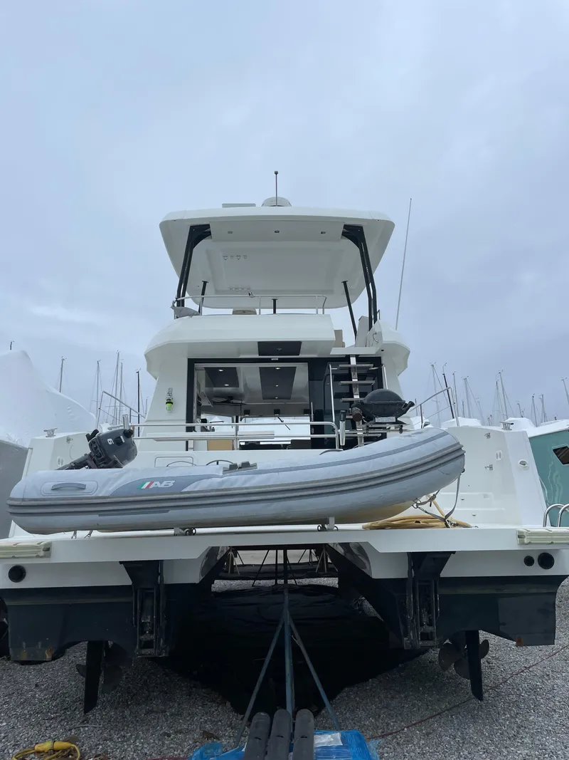 Slide: The Image of 2018 Fountaine Pajot MY 37 yacht with dinghy, docked on a cloudy day. - 4