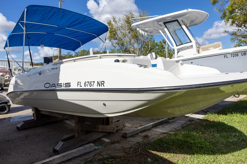 Slide: The Image of 2008 Key West 210 LS boat with blue canopy on display outdoors. - 1