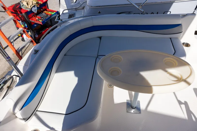 Slide: The Image of 2008 Key West 210 LS boat interior with cushioned seating and round table. - 7