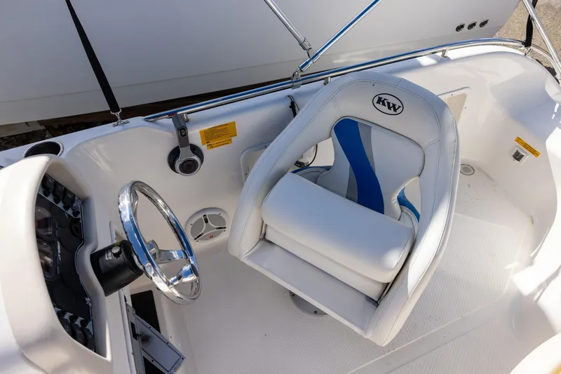 Slide: The Image of 2008 Key West 210 LS boat interior with steering wheel and cushioned seat. - 8