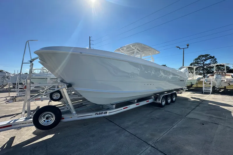 The Image of 2026 Twin Vee 340 GFX CC boat on trailer under clear blue sky. - 1
