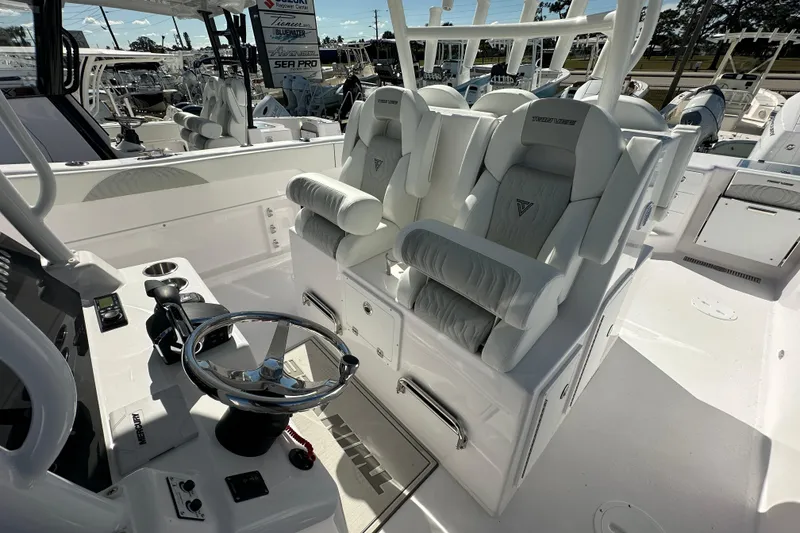 Slide: The Image of 2026 Twin Vee 340 GFX CC boat interior with luxurious seating and modern steering console. - 13