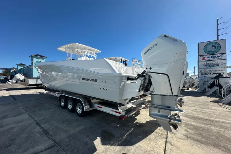 Slide: The Image of 2026 Twin Vee 340 GFX CC boat with Mercury engines on a trailer, sunny day. - 3