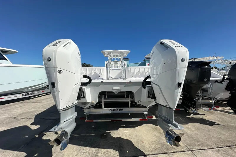 Slide: The Image of 2026 Twin Vee 340 GFX CC boat with dual outboard engines, displayed on a trailer. - 4