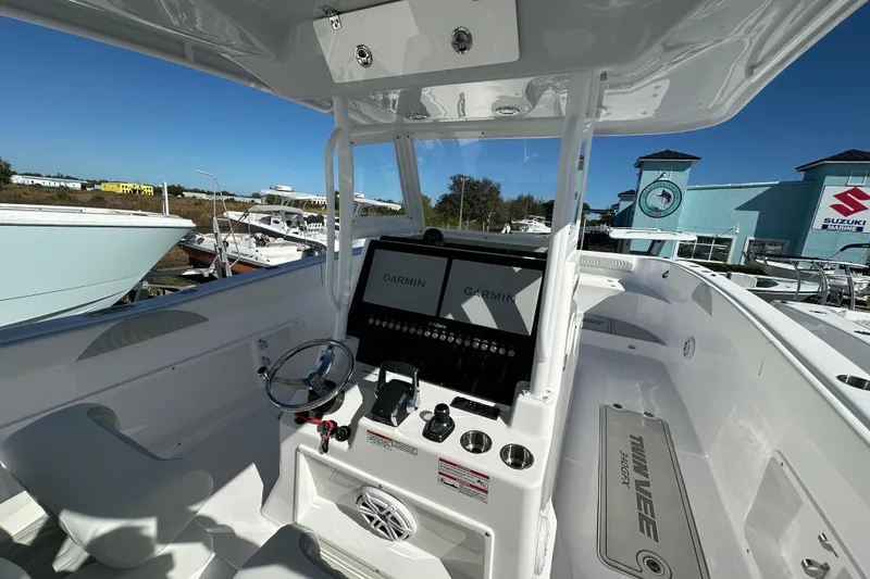 Slide: The Image of 2026 Twin Vee 340 GFX CC boat cockpit with Garmin navigation system, steering wheel, and controls. - 6