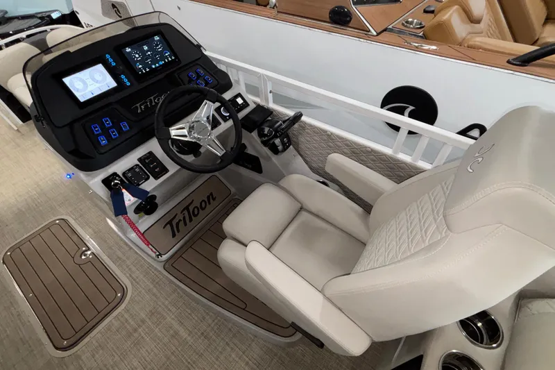 Slide: The Image of Luxurious helm of 2026 JC Sporttoon 26TT boat with advanced controls and plush seating. - 15