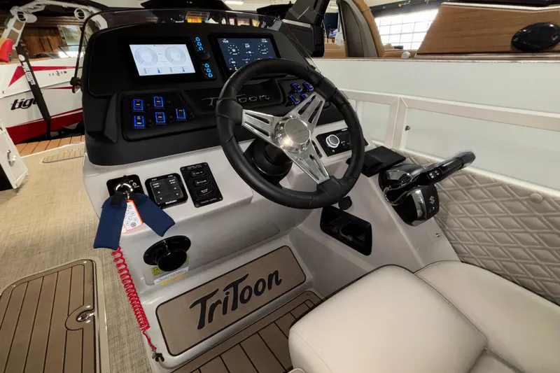 Slide: The Image of 2026 JC Sporttoon 26TT boat dashboard with steering wheel and control panel. - 16