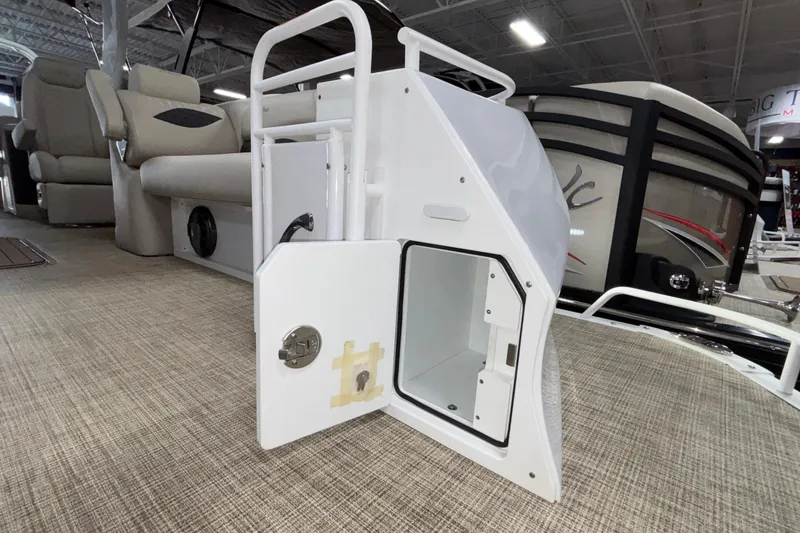 Slide: The Image of 2026 JC Sporttoon 26TT boat interior with open storage compartment and seating. - 2