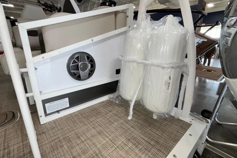 Slide: The Image of 2026 JC Sporttoon 26TT boat interior with speaker and wrapped accessories. - 28
