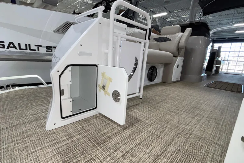 Slide: The Image of 2026 JC Sporttoon 26TT boat interior with open storage compartment and seating area. - 3