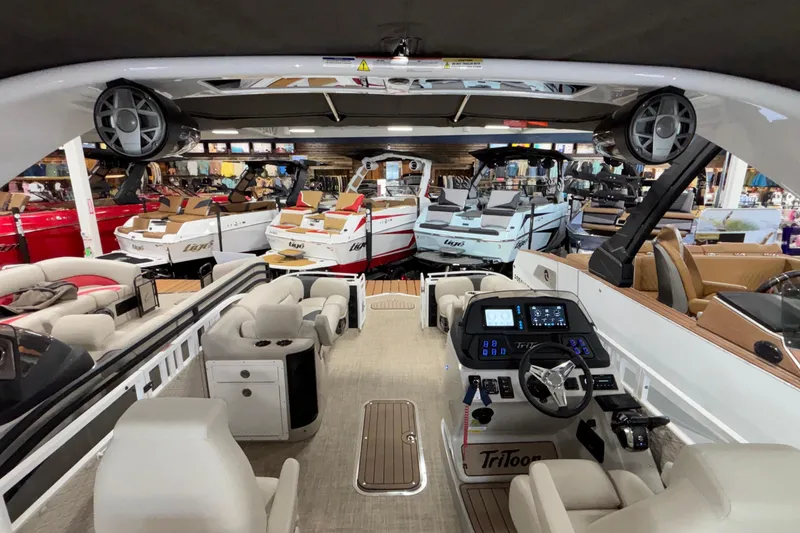 Slide: The Image of Interior view of a 2026 JC Sporttoon 26TT boat in a showroom. - 41