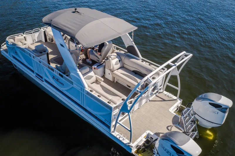 Slide: The Image of 2026 JC Sporttoon 26TT pontoon boat with dual engines on a calm lake. - 55