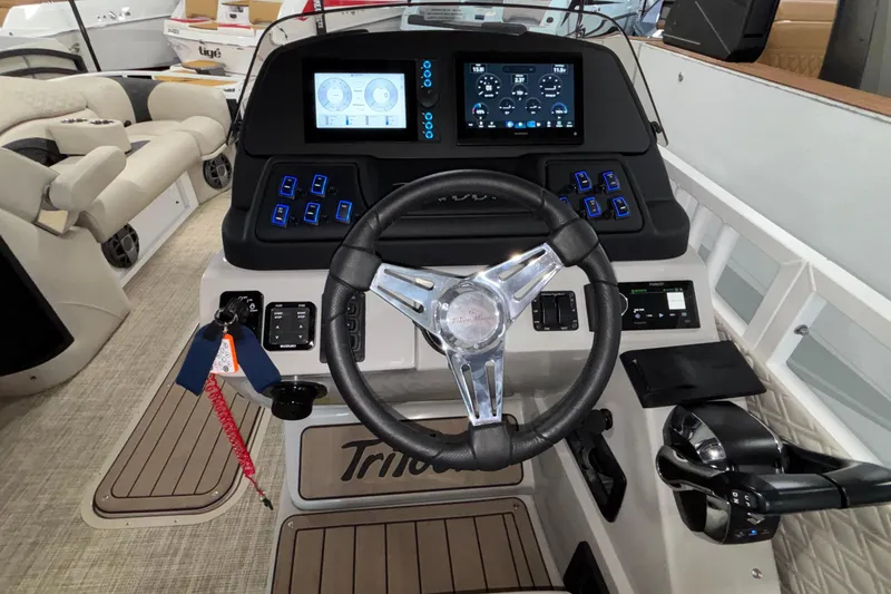 Slide: The Image of Steering console of 2026 JC Sporttoon 26TT boat with modern controls and displays. - 17