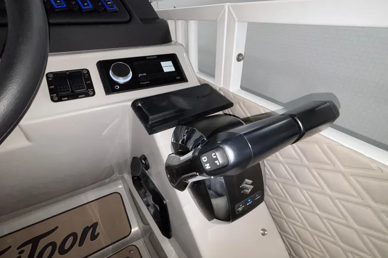 Slide: The Image of Control panel of 2026 JC Sporttoon 26TT boat with throttle and audio system. - 18
