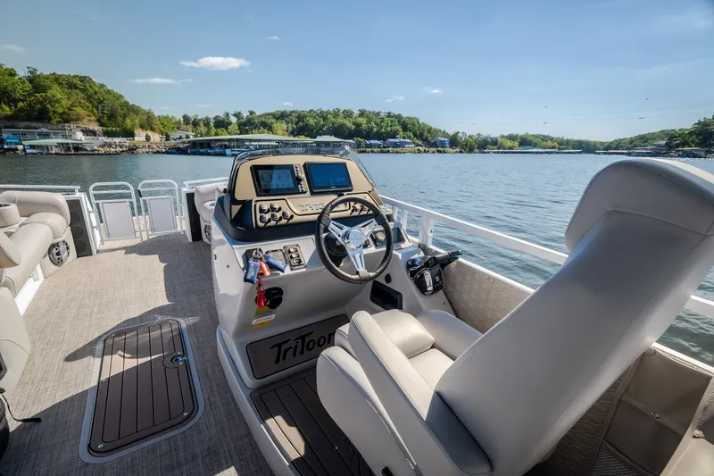 Slide: The Image of Luxury JC Sporttoon 26TT pontoon boat interior, 2026 model, on a scenic lake. - 33