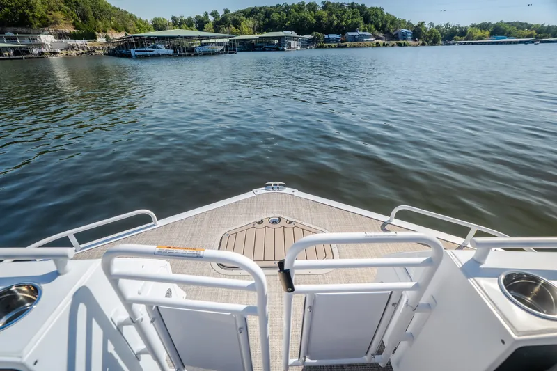 Slide: The Image of Front deck view of 2026 JC Sporttoon 26TT pontoon boat on a serene lake. - 28