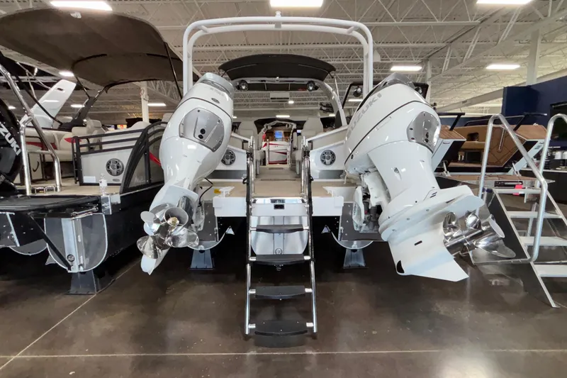Slide: The Image of 2026 JC Sporttoon 26TT boat with dual outboard motors in showroom. - 38
