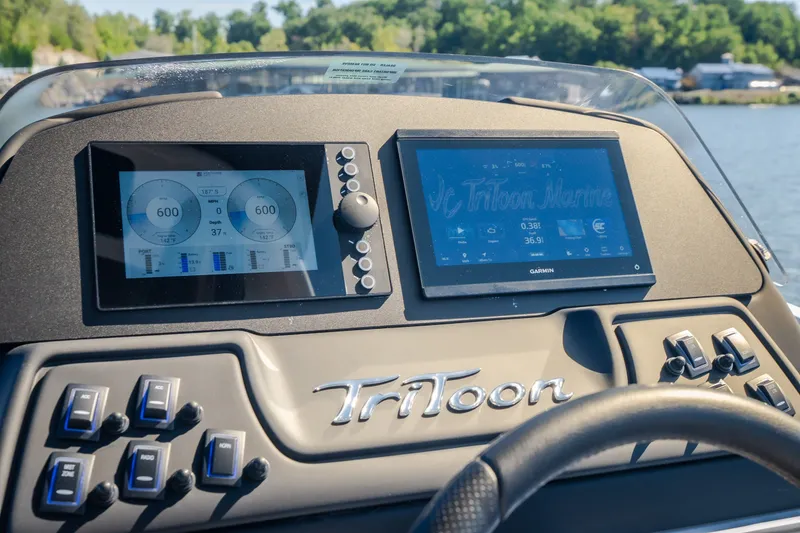 Slide: The Image of Dashboard of 2026 JC Sporttoon 26TT boat with digital displays and controls. - 36