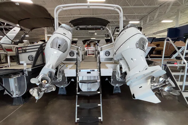 Slide: The Image of 2026 JC Sporttoon 26TT boat with dual outboard motors in showroom. - 39