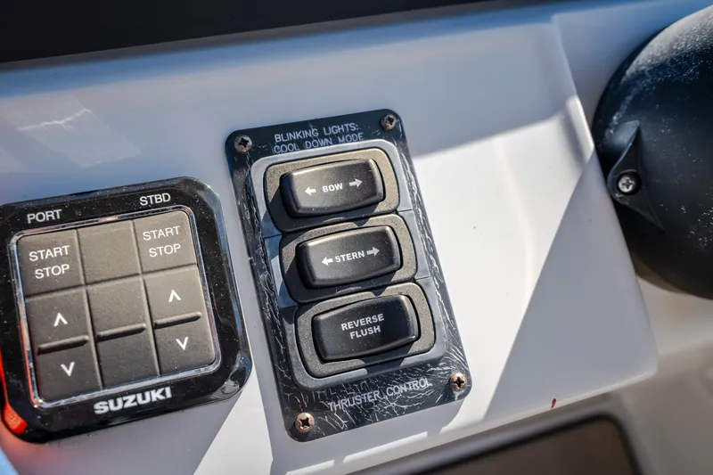 Slide: The Image of Control panel of 2026 JC Sporttoon 26TT boat with Suzuki start-stop buttons. - 41