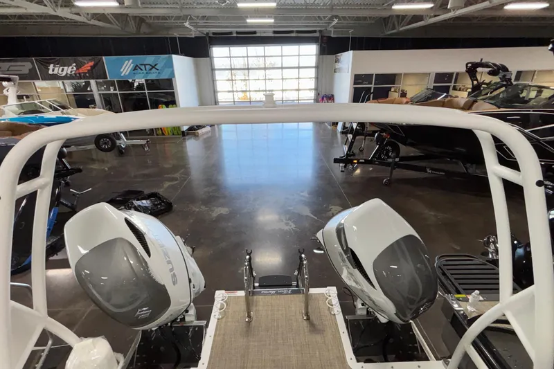 Slide: The Image of 2026 JC Sporttoon 26TT boat with dual outboard motors in showroom. - 40