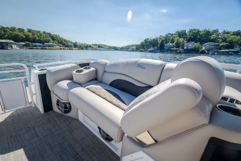 Slide: The Image of Luxurious seating on 2026 JC Sporttoon 26TT pontoon boat, cruising on a scenic lake. - 24