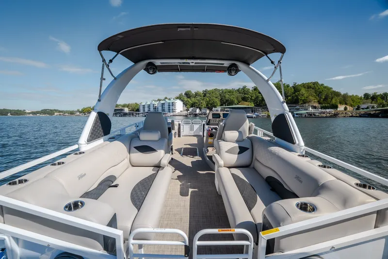 Slide: The Image of Luxurious 2026 JC Sporttoon 26TT pontoon boat with spacious seating on a sunny lake. - 8