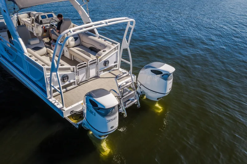 Slide: The Image of Modern JC Sporttoon 26TT pontoon boat with dual Suzuki engines on a calm lake. - 5
