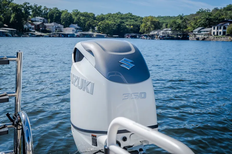 Slide: The Image of Outboard motor on JC Sporttoon 26TT boat, 2026 model, on a scenic lake. - 49