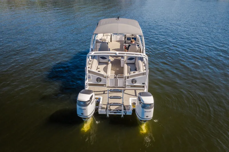Slide: The Image of 2026 JC Sporttoon 26TT pontoon boat on calm water, rear view with dual engines. - 3