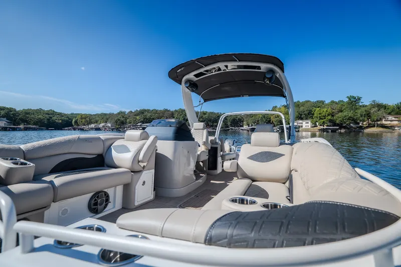 Slide: The Image of Luxurious 2026 JC Sporttoon 26TT pontoon boat interior on a serene lake. - 30