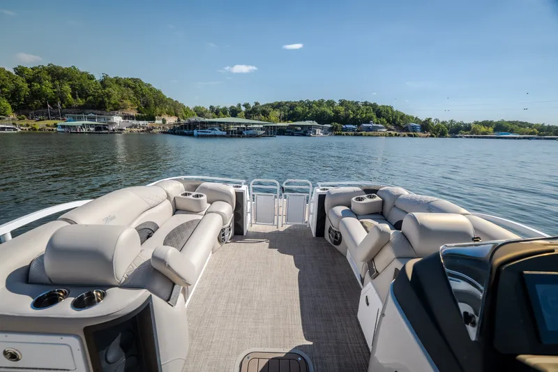 Slide: The Image of Luxurious 2026 JC Sporttoon 26TT pontoon boat with plush seating on a serene lake. - 22