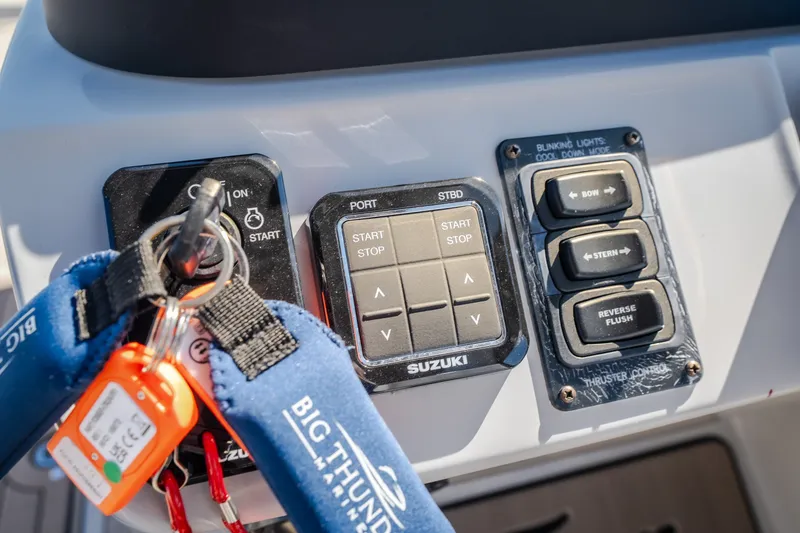 Slide: The Image of Control panel of a 2026 JC Sporttoon 26TT boat with keys and switches. - 53