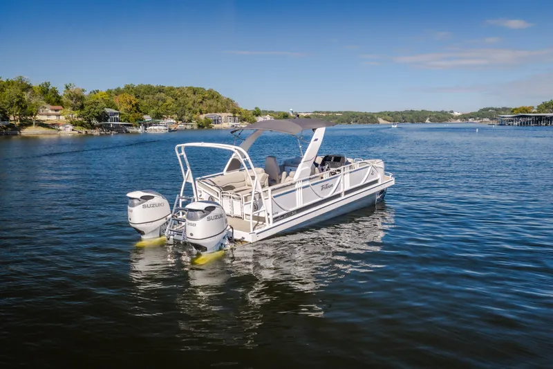 Slide: The Image of 2026 JC Sporttoon 26TT pontoon boat with dual Suzuki engines on a scenic lake. - 57