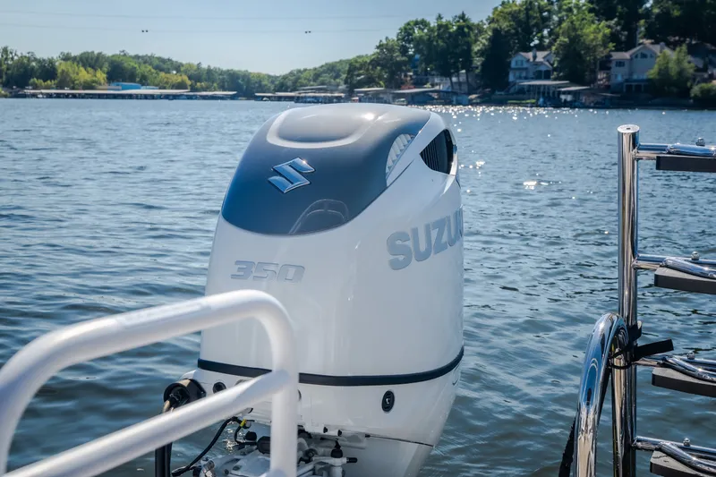 Slide: The Image of Outboard motor on JC Sporttoon 26TT boat, 2026 model, on a scenic lake. - 48