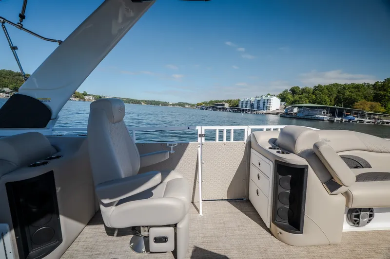 Slide: The Image of Interior view of 2026 JC Sporttoon 26TT boat on a scenic lake. - 19