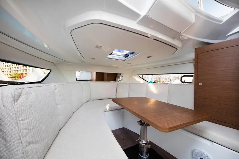 Slide: The Image of Manufacturer Provided Image: Interior of 2019 Jeanneau Leader 10.5 with white seating and wooden table. - 12