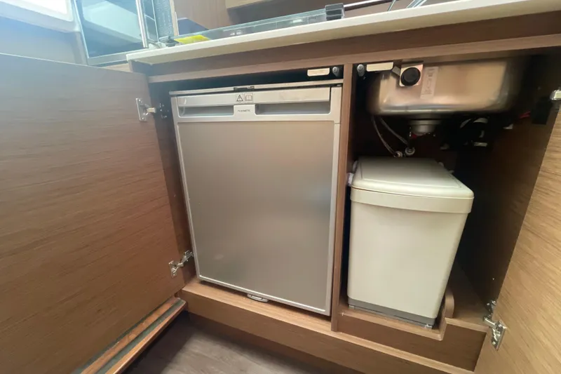 Slide: The Image of Compact kitchen area in a 2019 Jeanneau Leader 10.5 boat with fridge and sink. - 16