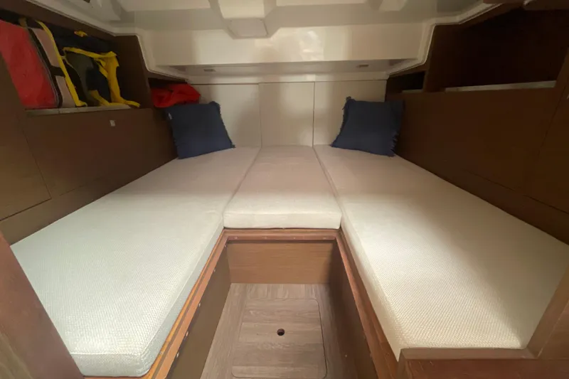 Slide: The Image of Interior cabin of 2019 Jeanneau Leader 10.5 with cushioned seating and storage. - 18