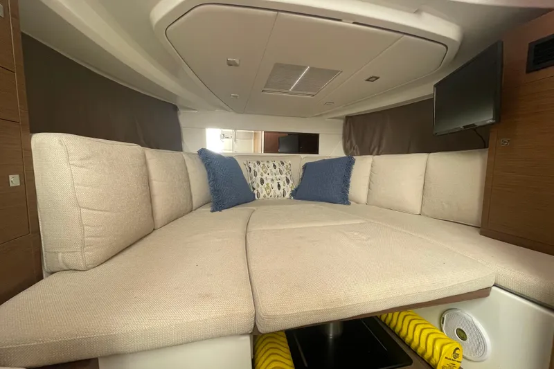 Slide: The Image of Interior of 2019 Jeanneau Leader 10.5 boat with cozy seating and cushions. - 19