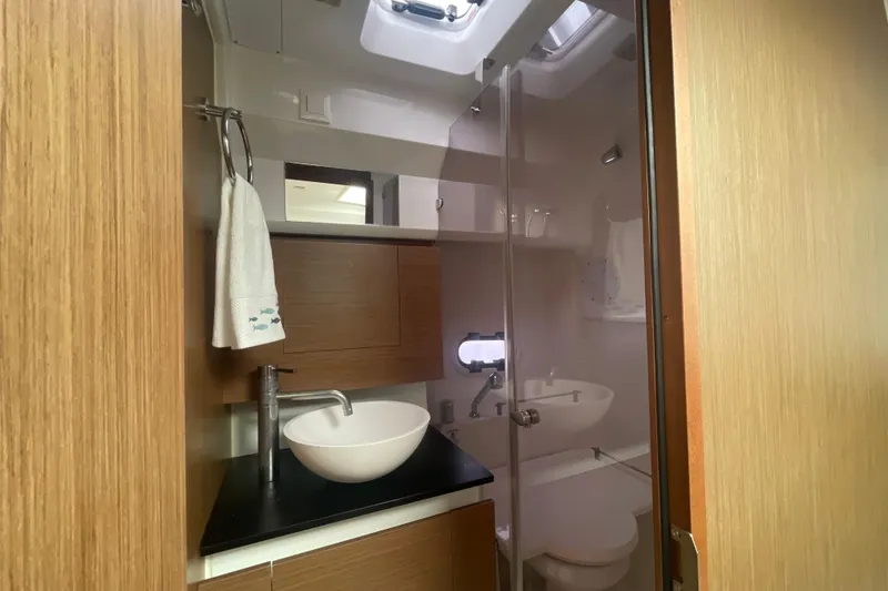 Slide: The Image of 2019 Jeanneau Leader 10.5 yacht bathroom with modern sink and wooden cabinetry. - 22